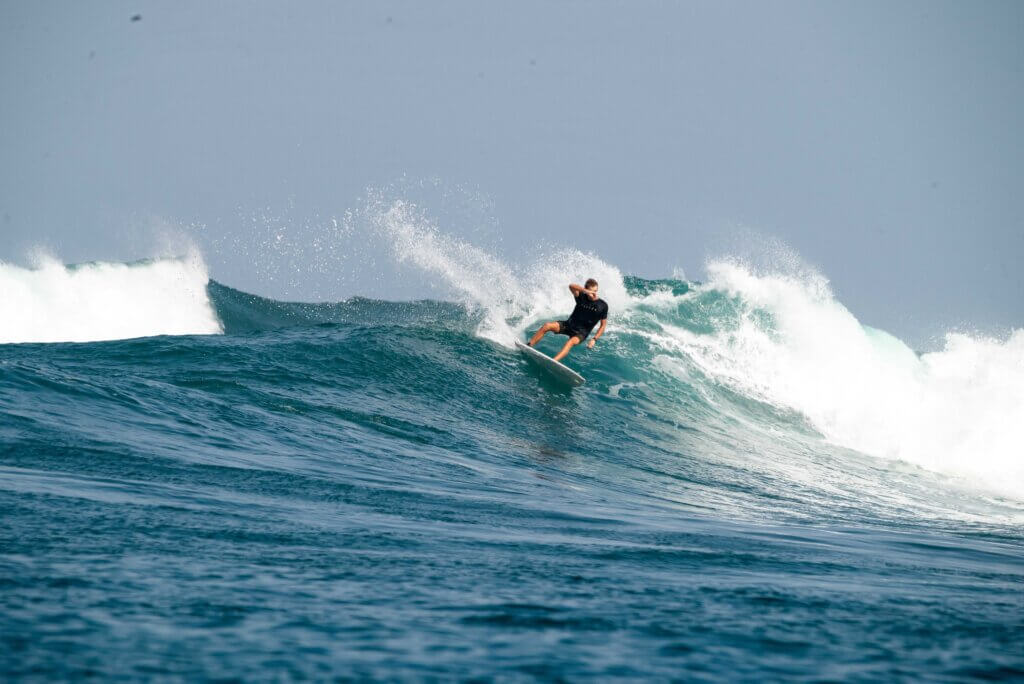 In-water surf photography capturing a surfer in action