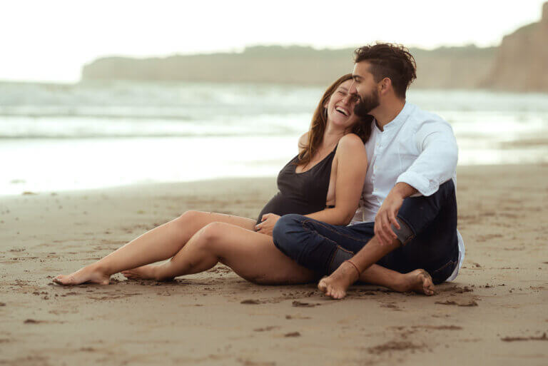 couple pregnancy photo session in the beach