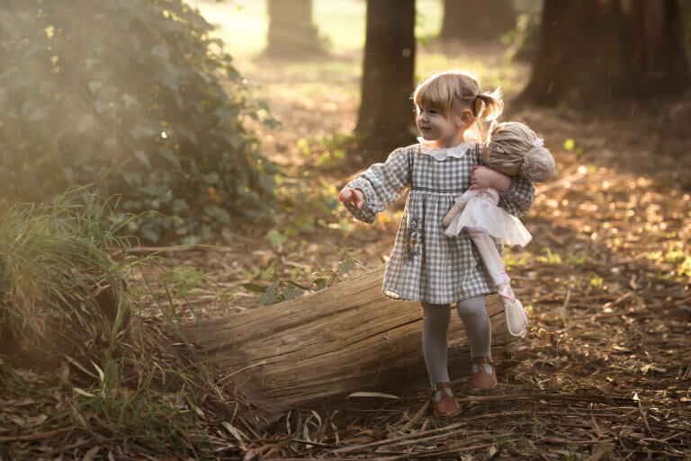 little girl playing in the forest