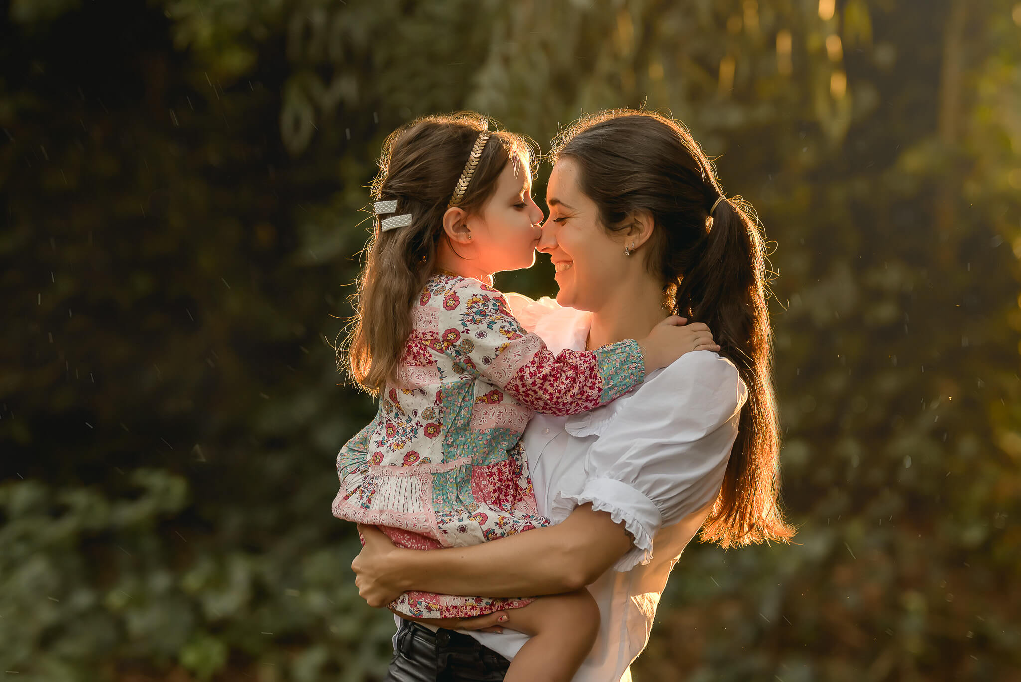 Mother and daughter at sunset in the forest