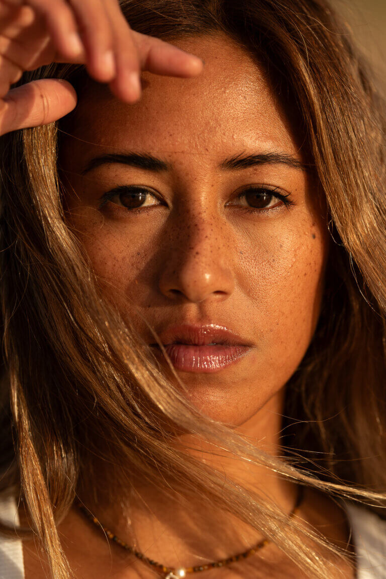 Female portrait at the beach during sunset